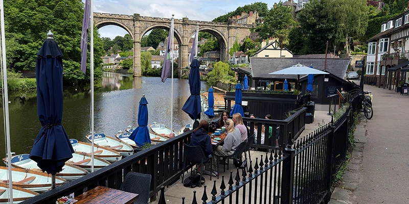 Tables on the riverside restaurant terrace at Knaresborough