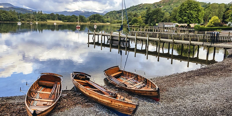 Wooden rowing boats moored at a jetty on Lake Windermere