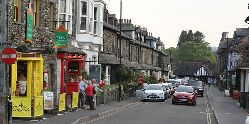 Shops and a red telephone box on a street in central Ambleside