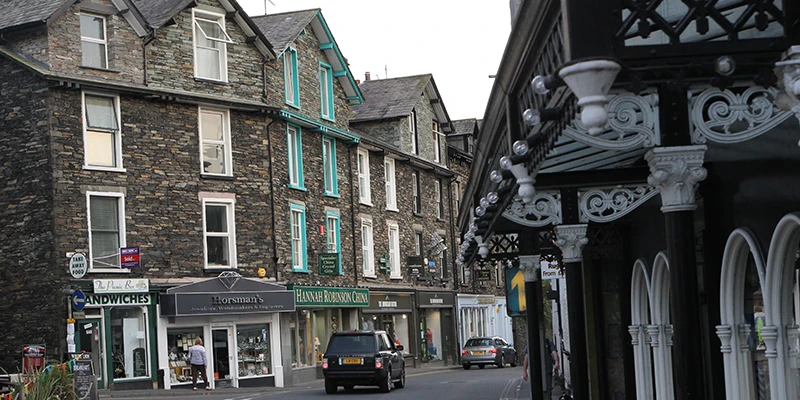 Painted shopfronts along a slate-built street in Ambleside