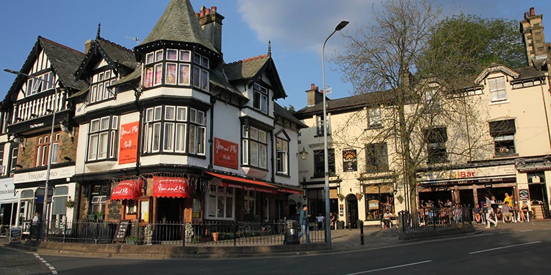 A street corner lined with shops in Bowness