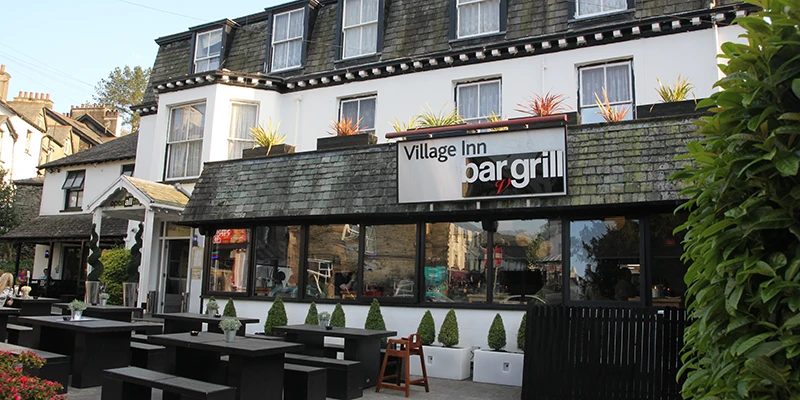 A lakeside bar and grill with outdoor seating in Bowness