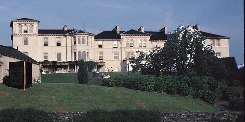 A traditional Lake District hotel set back on a lawn in Bowness