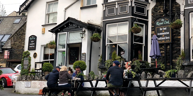 An outdoor pub terrace beside the water in Bowness