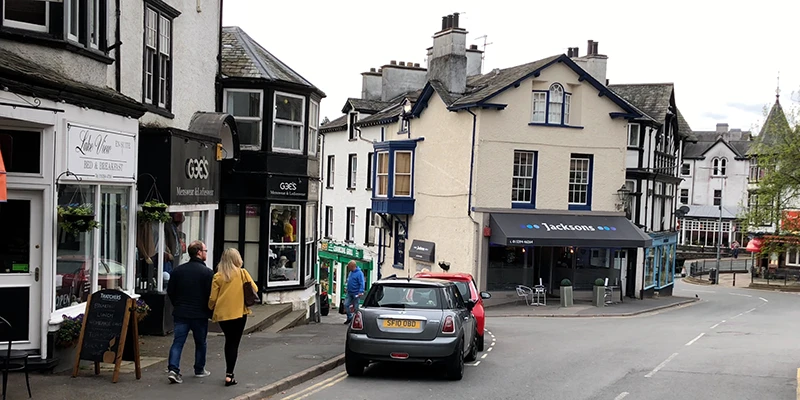 A quiet Bowness street with stone buildings