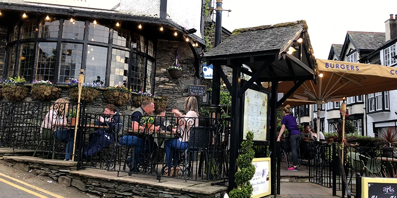 Outdoor seating at a popular Bowness pub