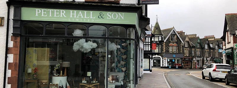 Peter Hall and Son shopfront with a green sign on a Windermere corner