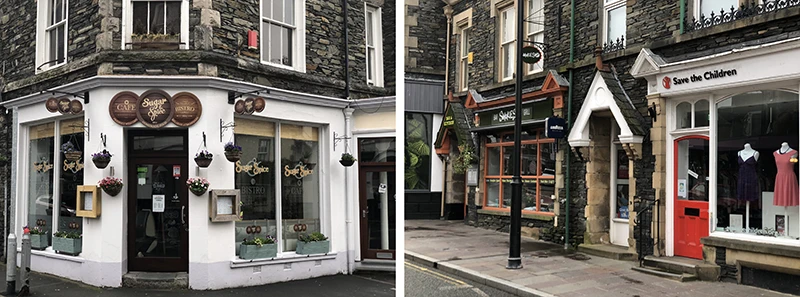 Corner shop with hanging baskets and a street of small stores in Windermere