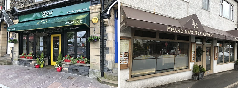 Restaurant fronts with green and brown signage in central Windermere