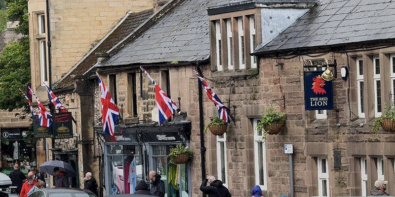 A Bakewell street lined with buildings and Union Jack flags