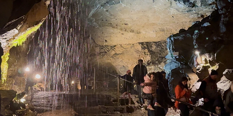 Inside the great lit chamber of a Castleton show cave