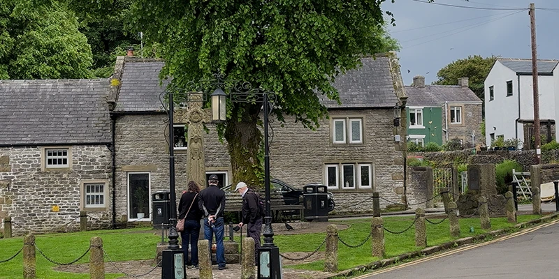 The village street and old cross in the center of Castleton