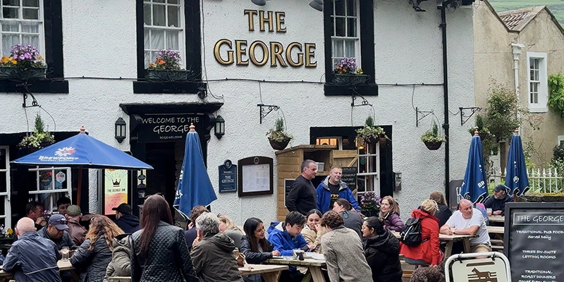 Diners outside The George pub in Castleton
