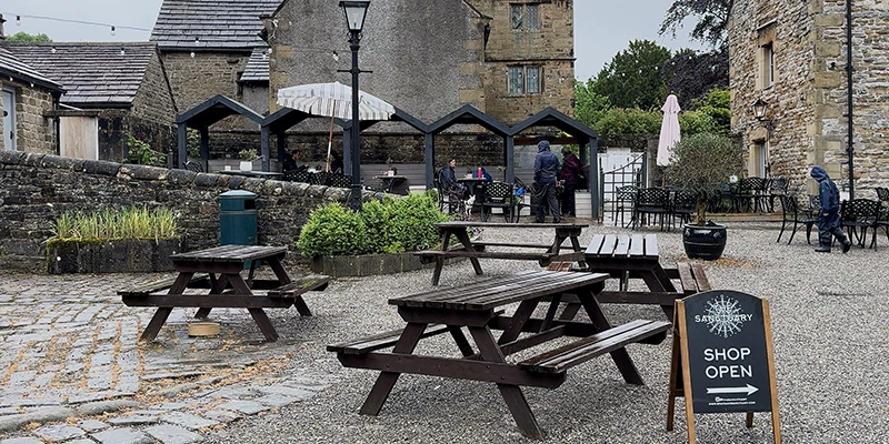 Picnic tables outside a tea room in the center of Eyam