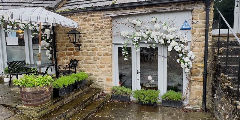Flower-decked shopfront in Eyam