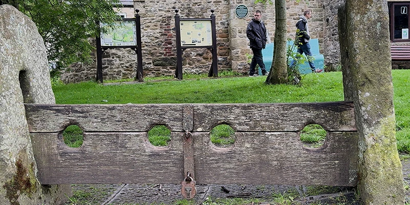 Historic stone trough and wall in Eyam