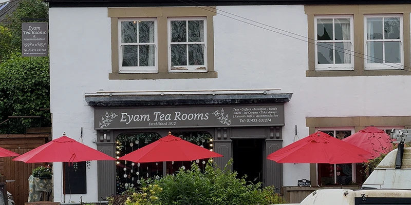 The Eyam Tea Rooms with red umbrellas on the terrace