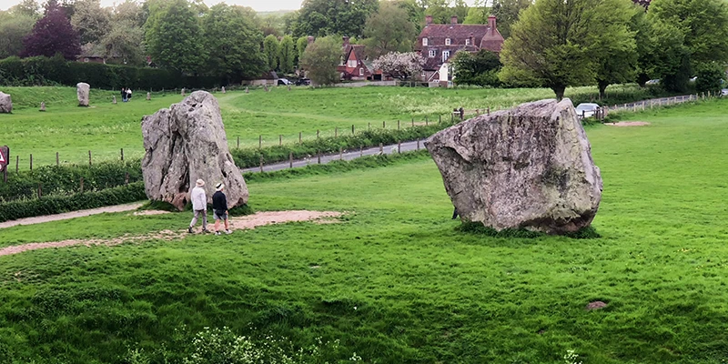 Standing stones at Avebury with trees and blossom behind