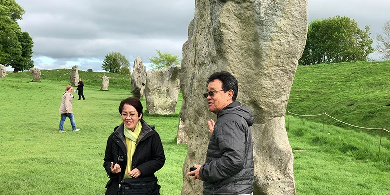 Visitors walking freely among the stones at Avebury