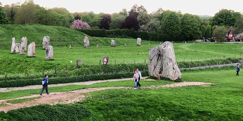 People walking between the standing stones at Avebury