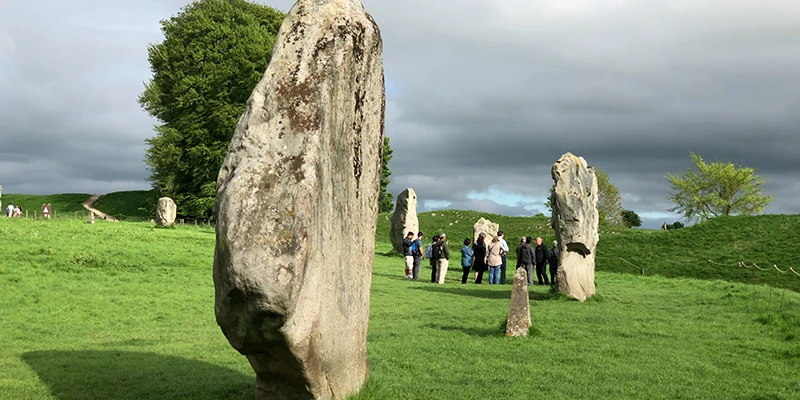 The line of stones at Avebury curving across the field