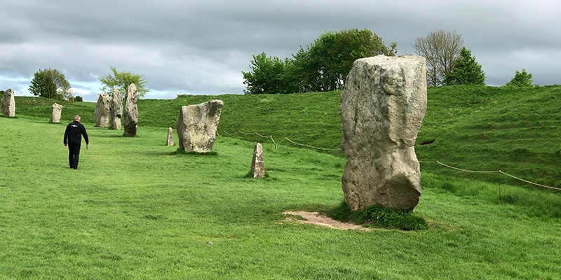 Widely spaced stones of the Avebury circle with the surrounding bank