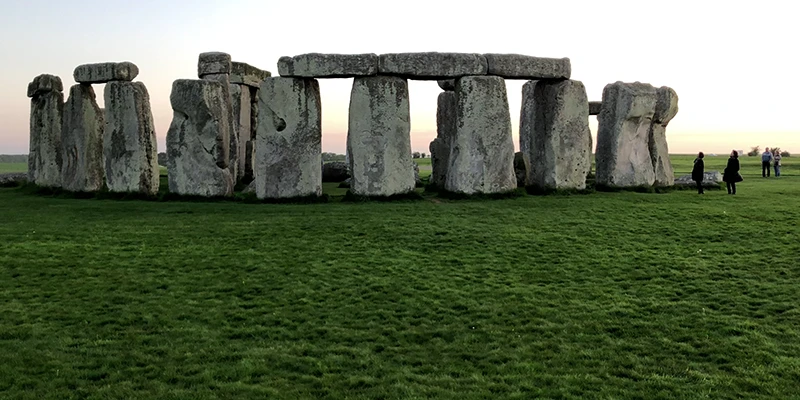 The standing stones of Stonehenge under a bright sky