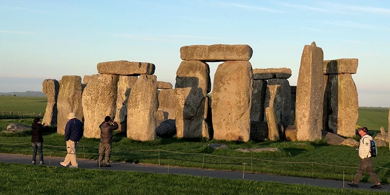 Stonehenge lit gold by the low evening sun