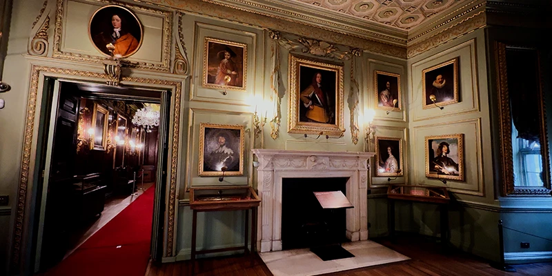 Silk wall coverings and plaster ceiling in a Greville family state room at Warwick Castle