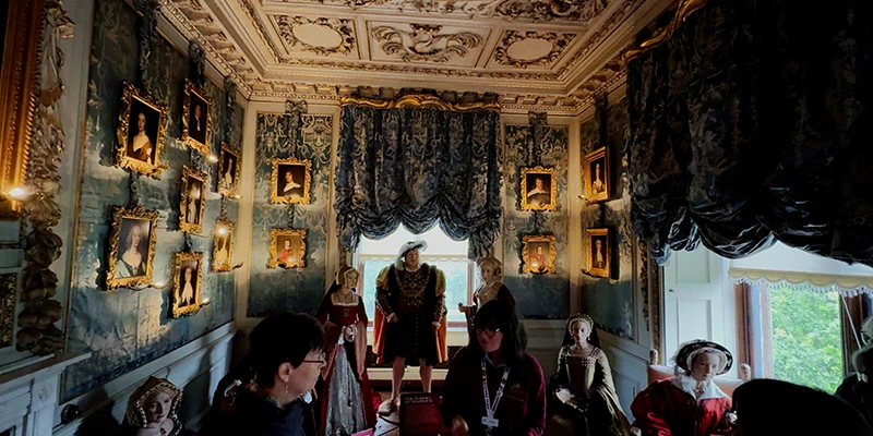 Visitors on a guided tour of the Warwick Castle state rooms