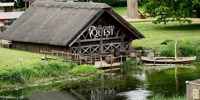 The thatched building beside the lake used as the arena for the Warwick Castle bird show