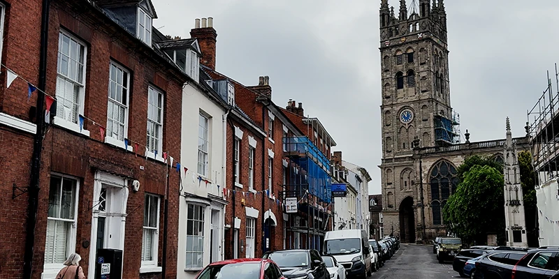 The tower of the Collegiate Church of St Mary standing above the rooftops of Warwick