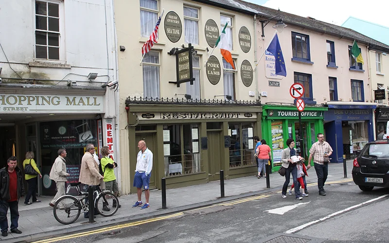 Shopfronts and pedestrians on a street in Killarney