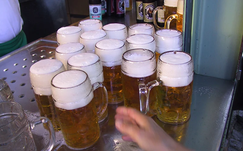 Glass steins of beer on a tray in Munich