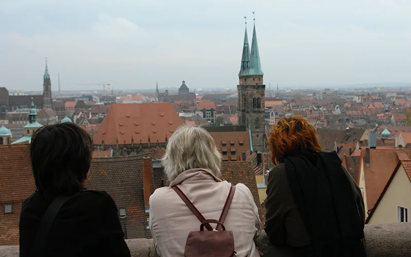 Visitors looking out over the rooftops and spires of Nuremberg