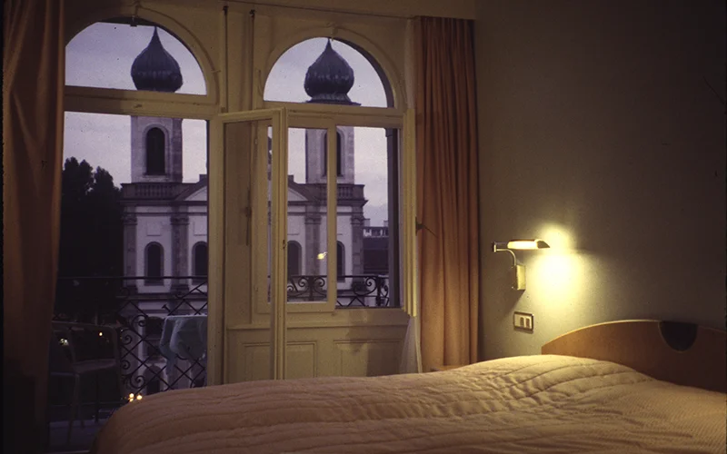 Hotel room in Lucerne with a church visible through the window
