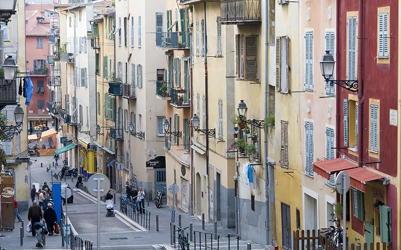Colorful shuttered houses along a narrow street in the south of France