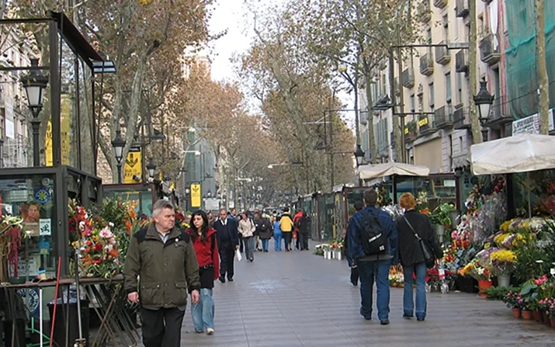 Flower stalls and pedestrians on La Rambla in Barcelona