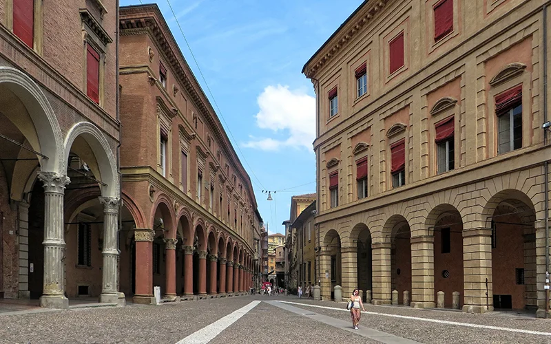 Arcaded streets in Bologna with red brick buildings