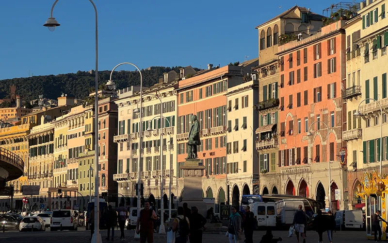 Grand palaces around a piazza in Genoa at dusk