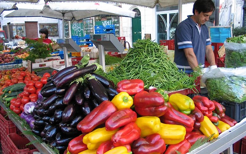 Peppers and vegetables displayed on an Italian market stall