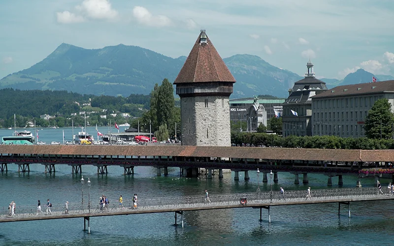 The water tower and Chapel Bridge in Lucerne with mountains beyond