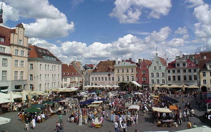The market square in the old town of Tallinn crowded with stalls and umbrellas