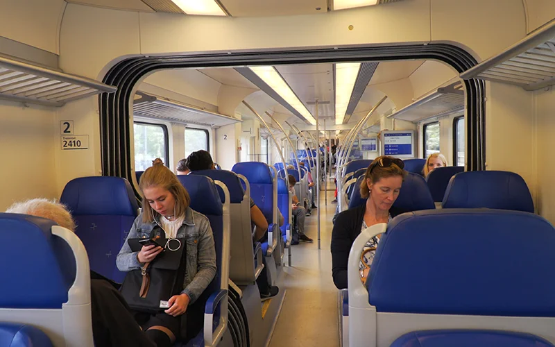 Interior of a European express train with passengers in second class seats