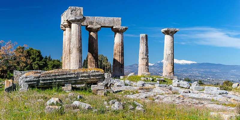 Temple of Apollo with snow-capped mountains beyond
