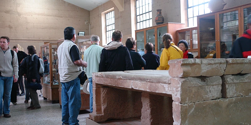 Visitors examining exhibits inside the Corinth museum