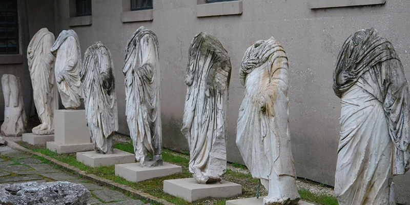 Row of headless marble statues in the Corinth museum