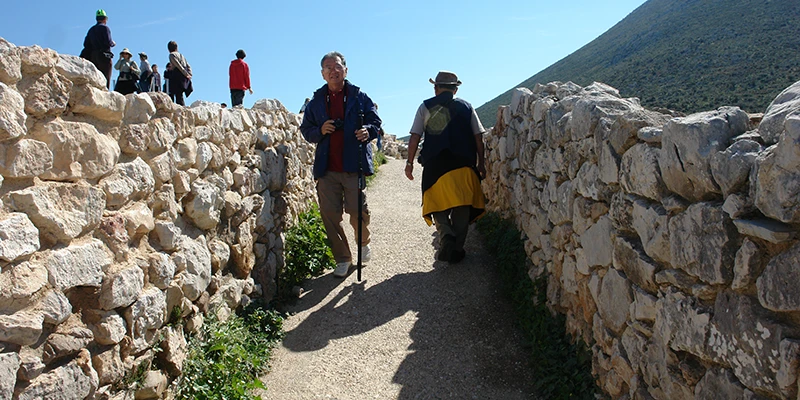 Visitors walking through the cyclopean walls of Mycenae