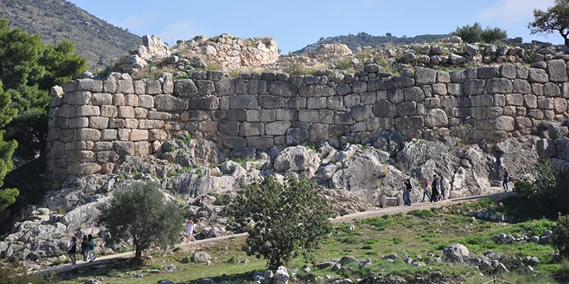 Cyclopean walls of Mycenae with visitors on the path