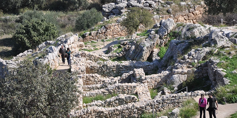 Ruined interior of the Mycenae citadel with visitors